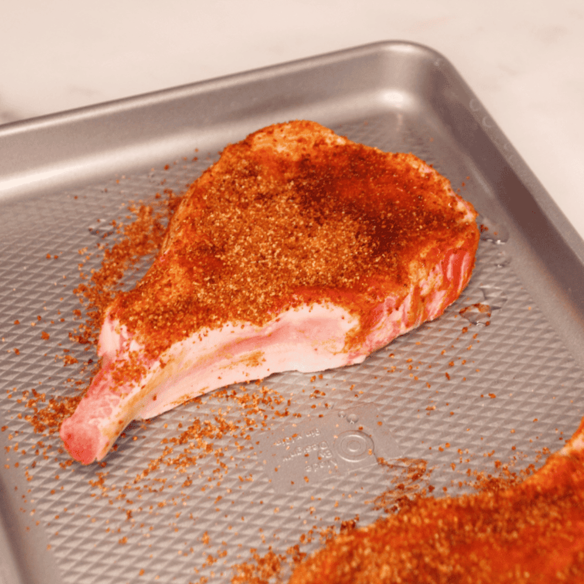 Rub the Chile Lime Seasoning Blend over the top of the pork chops.