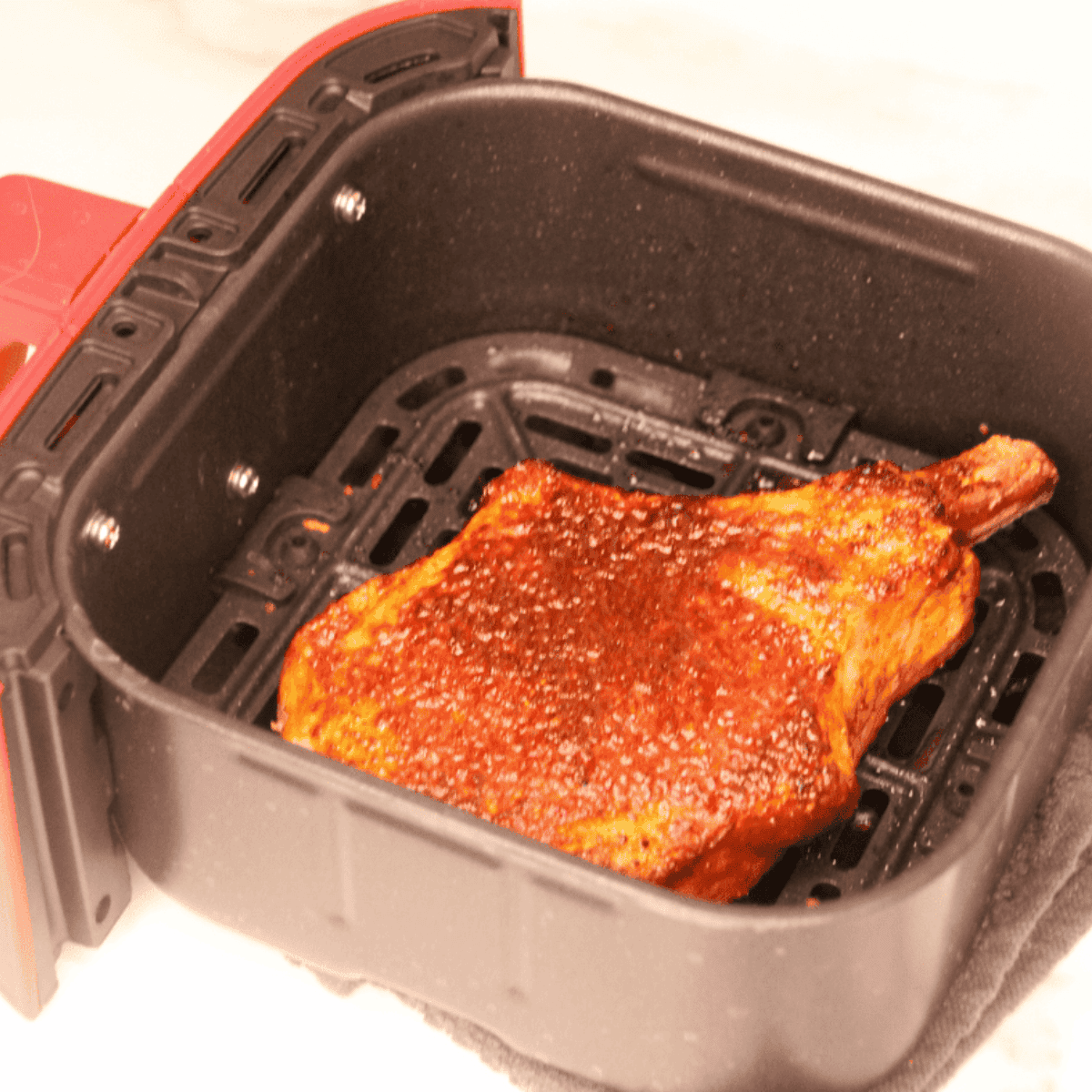 Cooked Chile Lime Pork Chop in the air fryer basket.