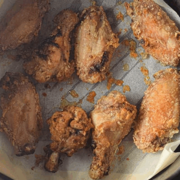 Cooking wings in the air fryer until golden and crispy.