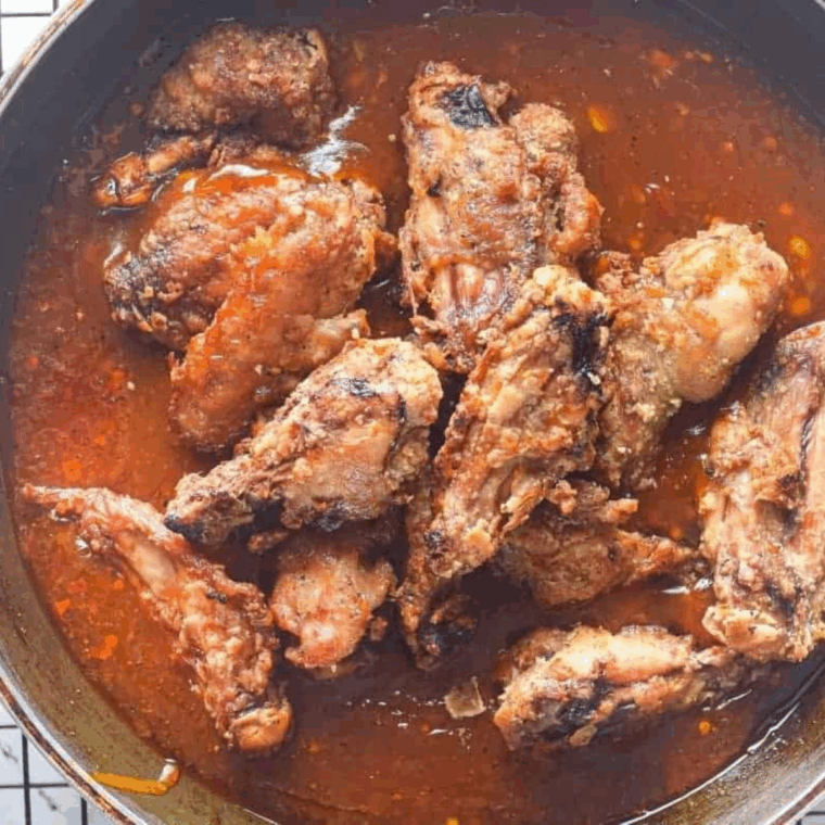 Plated sweet chili chicken wings served with dipping sauce.