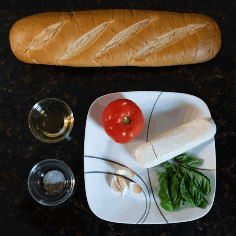 Ingredients needed for Air Fryer Tomato and Buffalo Mozzarella Bruschetta on kitchen table.
