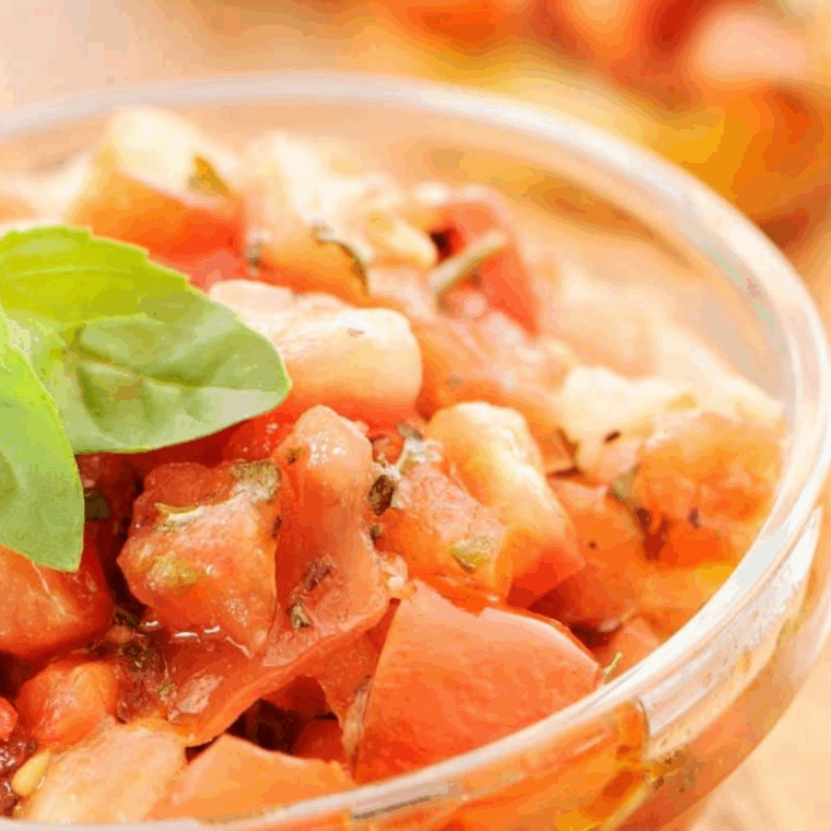 finely chopped basil and garlic added to tomato mozzarella mixture with olive oil