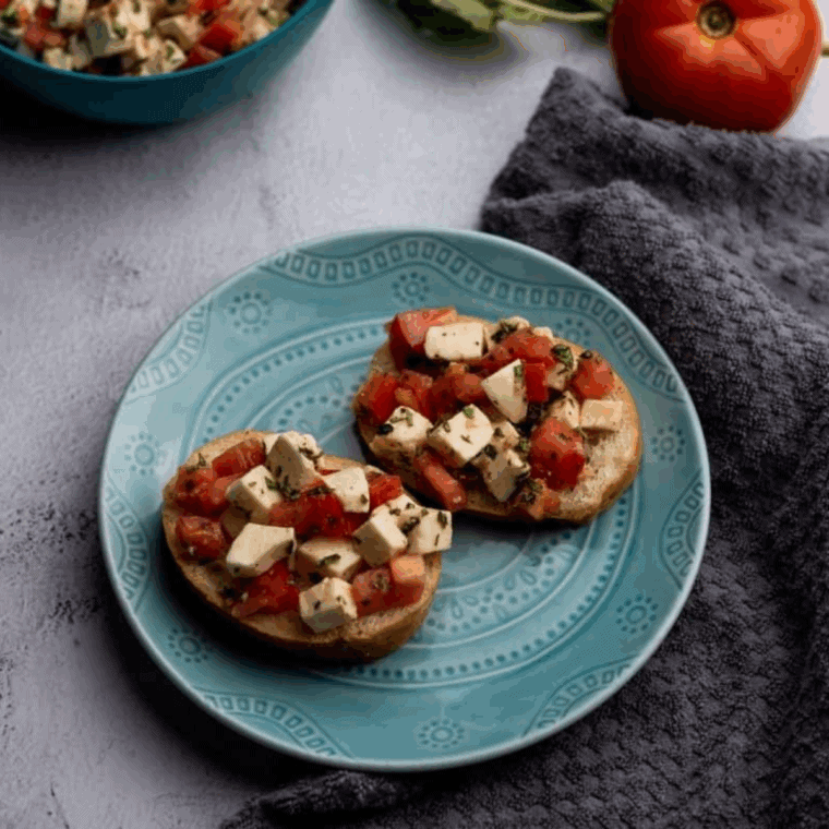 bruschetta mixture spooned onto toasted bread slices