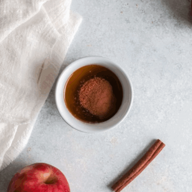 Bowl of butter, cinnamon, and brown sugar mixed into a smooth cinnamon filling