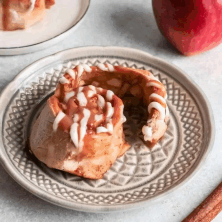 Freshly baked apple cinnamon rolls cooked in air fryer with cinnamon sugar and soft apple filling