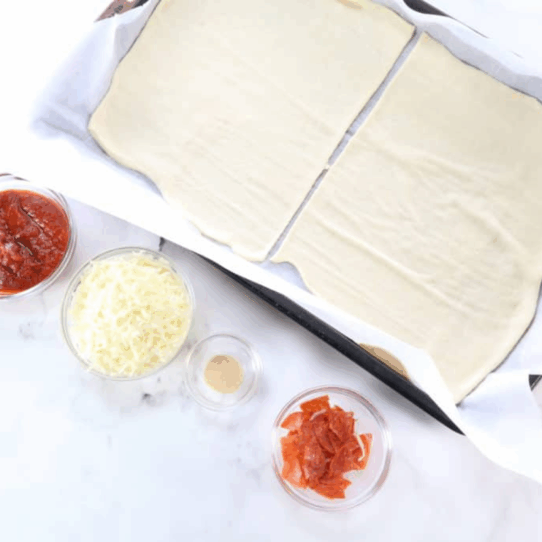 Ingredients needed for Easy Air Fryer Pepperoni Stromboli Recipe on kitchen table.