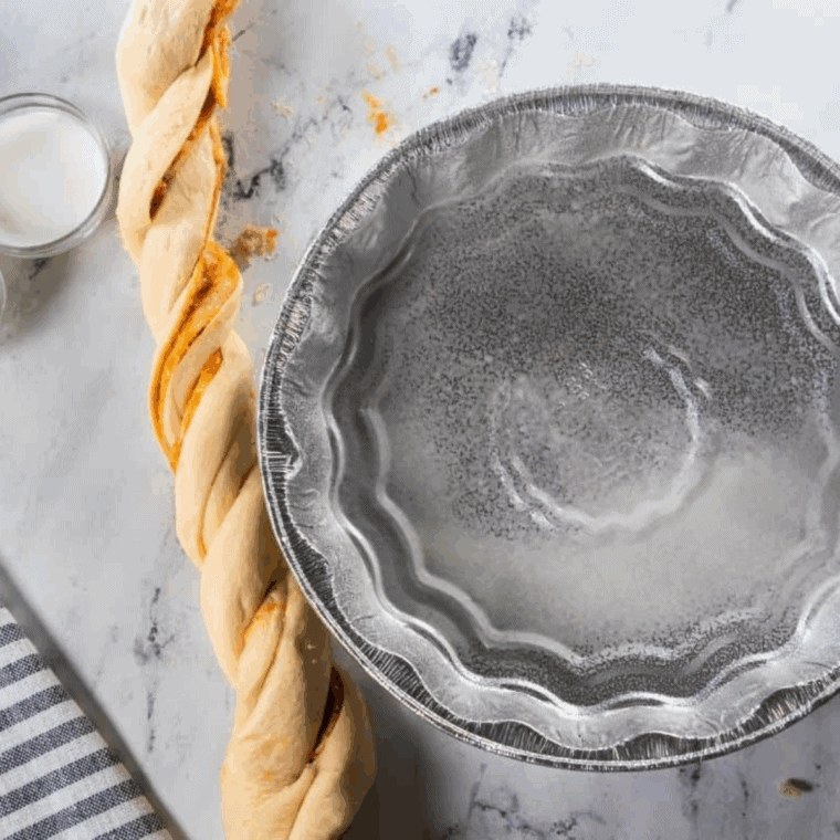 braided pumpkin spice dough made by slicing rolled crescent dough with a pizza cutter
