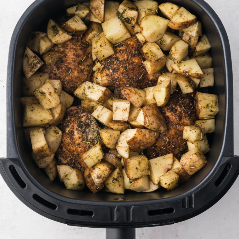 Jerk chicken thighs flipped halfway through cooking in the air fryer