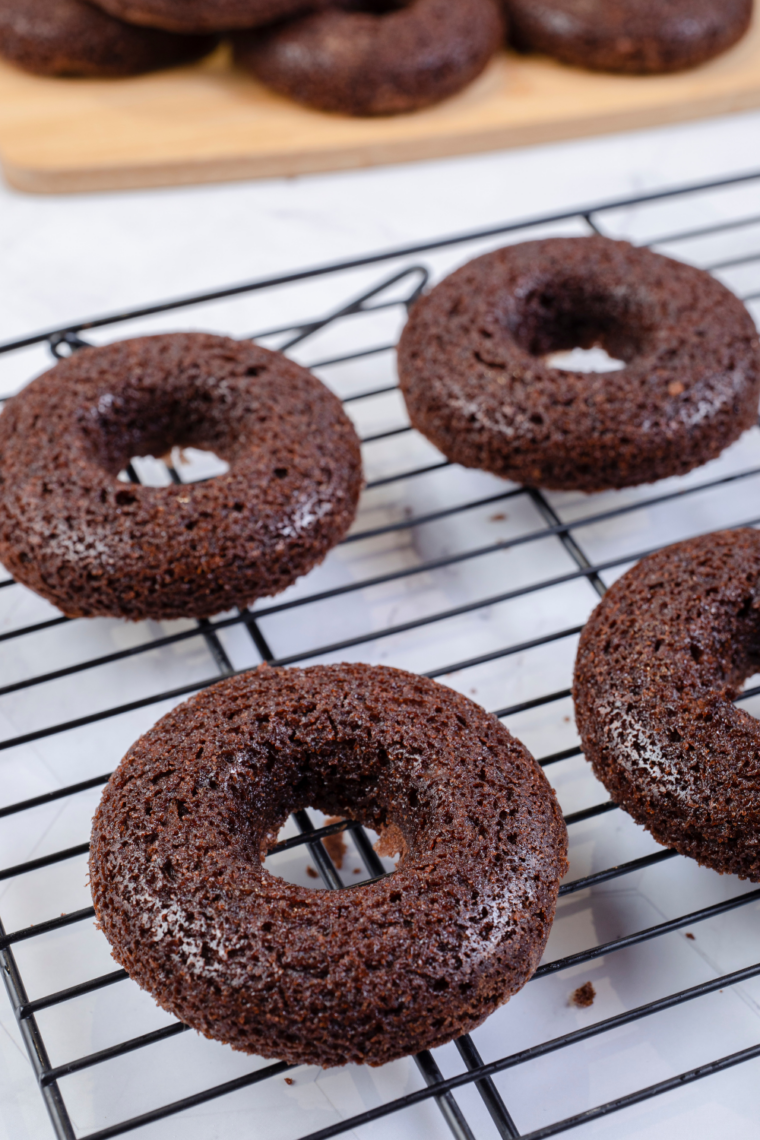 carefully cooling air fryer brownie donuts in silicone mold before removing and glazing