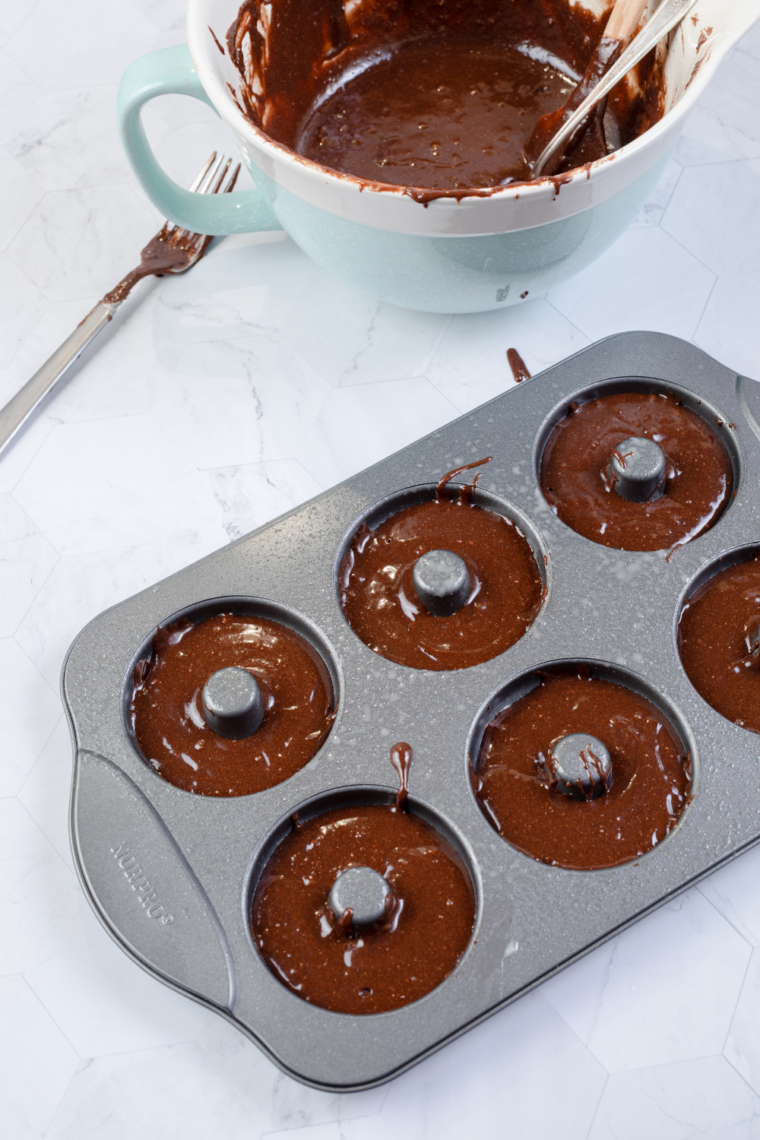 brownie batter poured into donut pan cavities about two thirds full