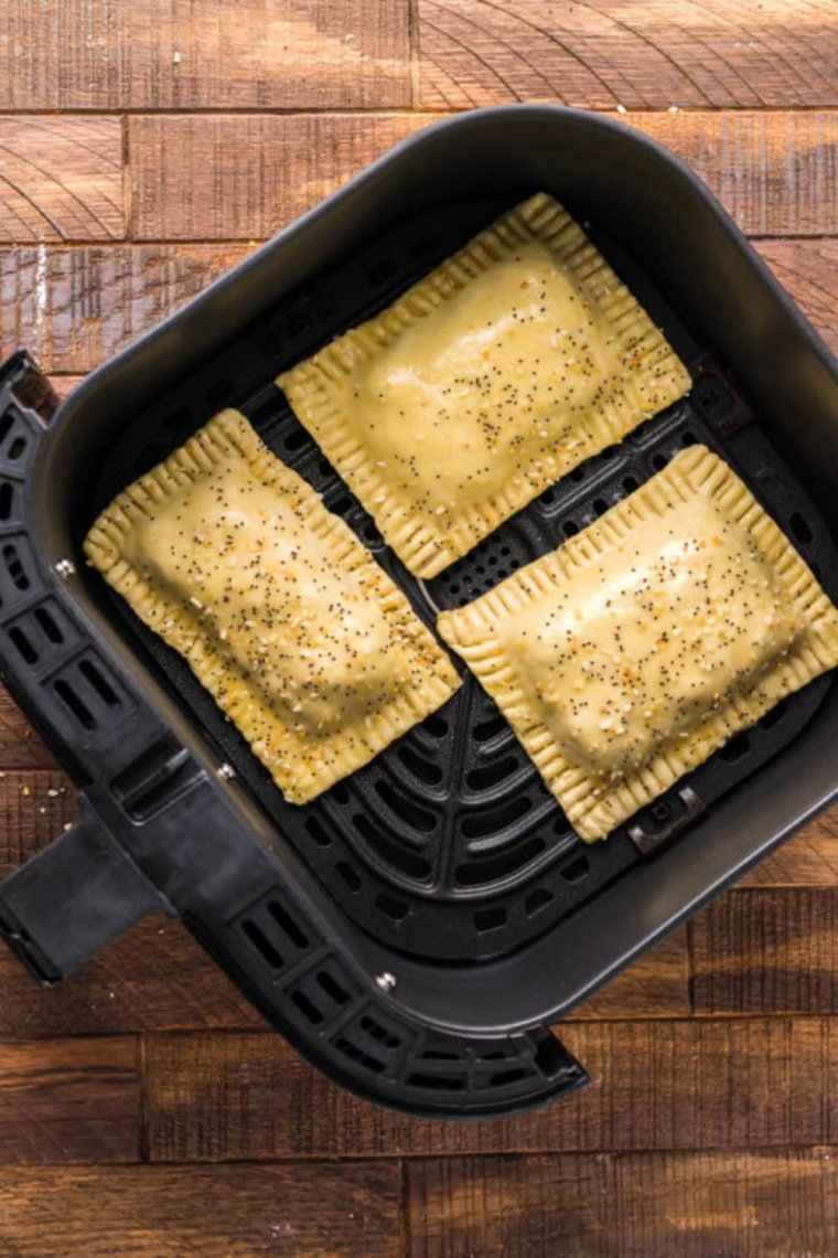 Stack of neatly cut puff pastry rectangles prepared for breakfast egg tarts