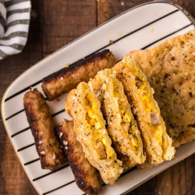 Air fryer breakfast egg tarts filled with scrambled eggs, cheese, and sausage