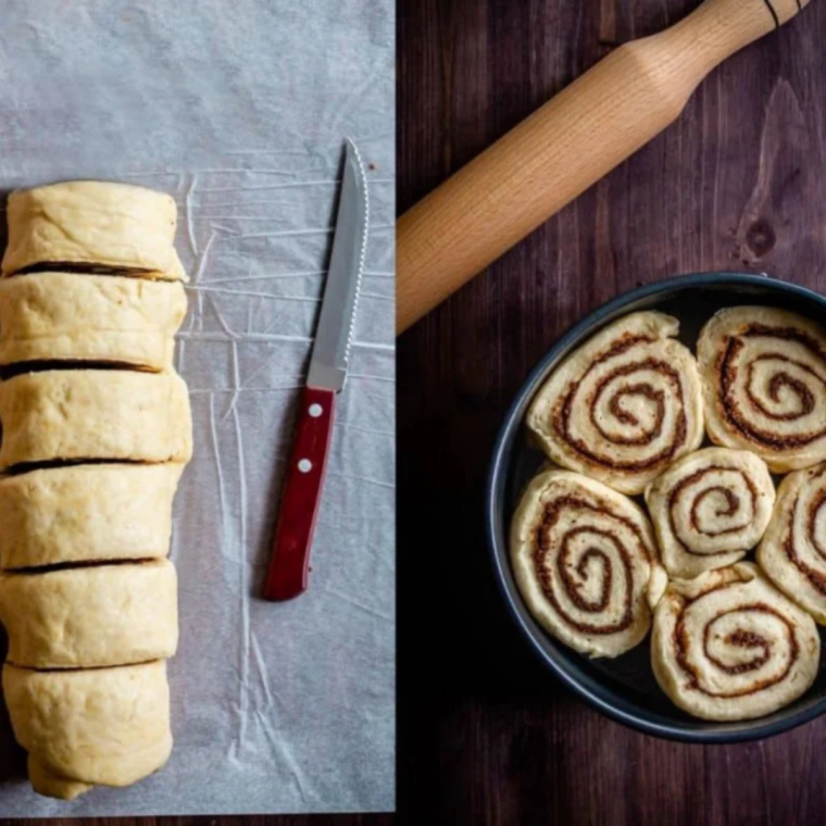 Unbaked cinnamon rolls rising in a buttered 9-inch round pan