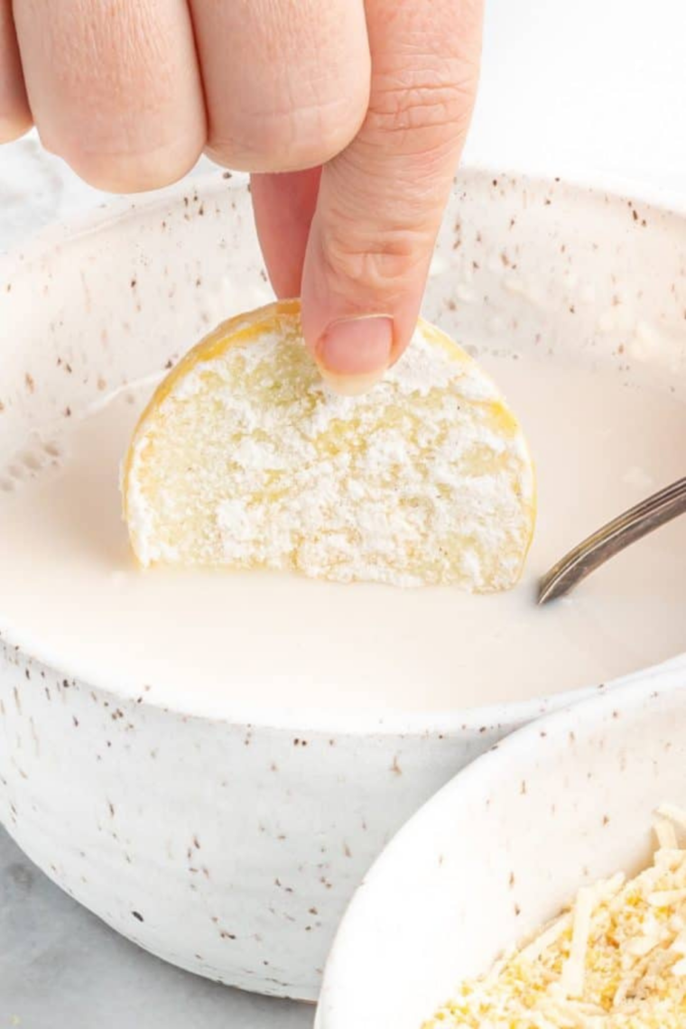 Squash slices coated in milk and cornstarch mixture for adhesion layer