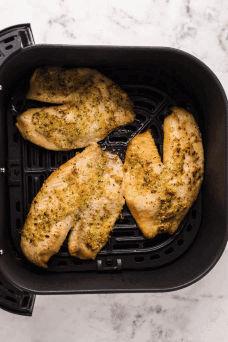 Cooked Air Fryer Frozen Tilapia in the air fryer basket.