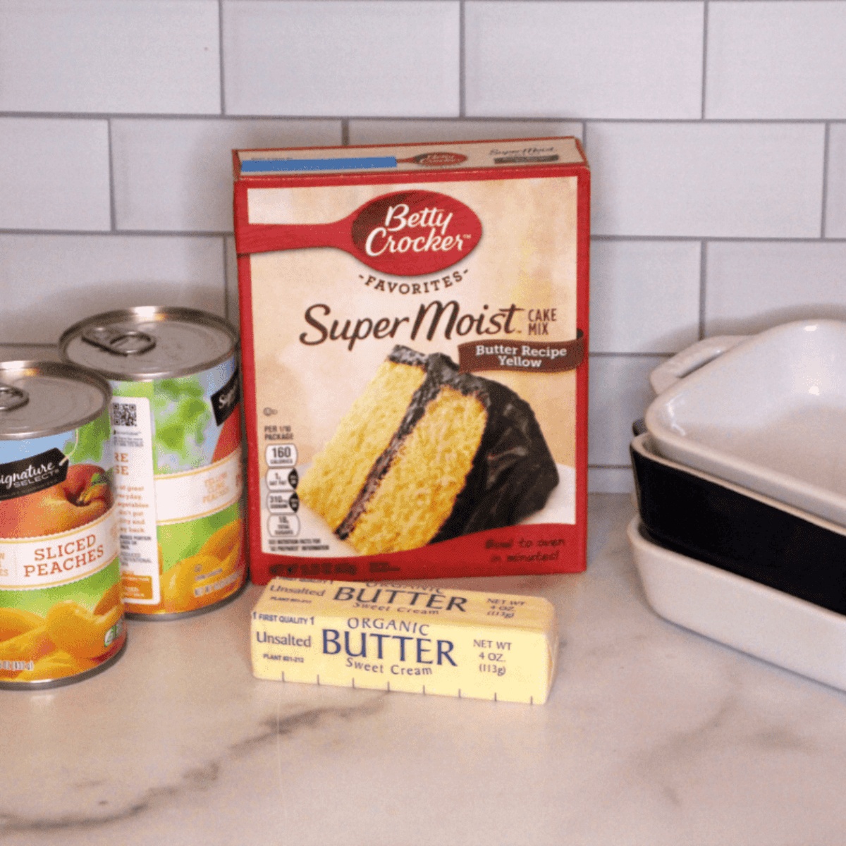 Ingredients needed for Easy Air Fryer Peach Dump Cake on kitchen table.