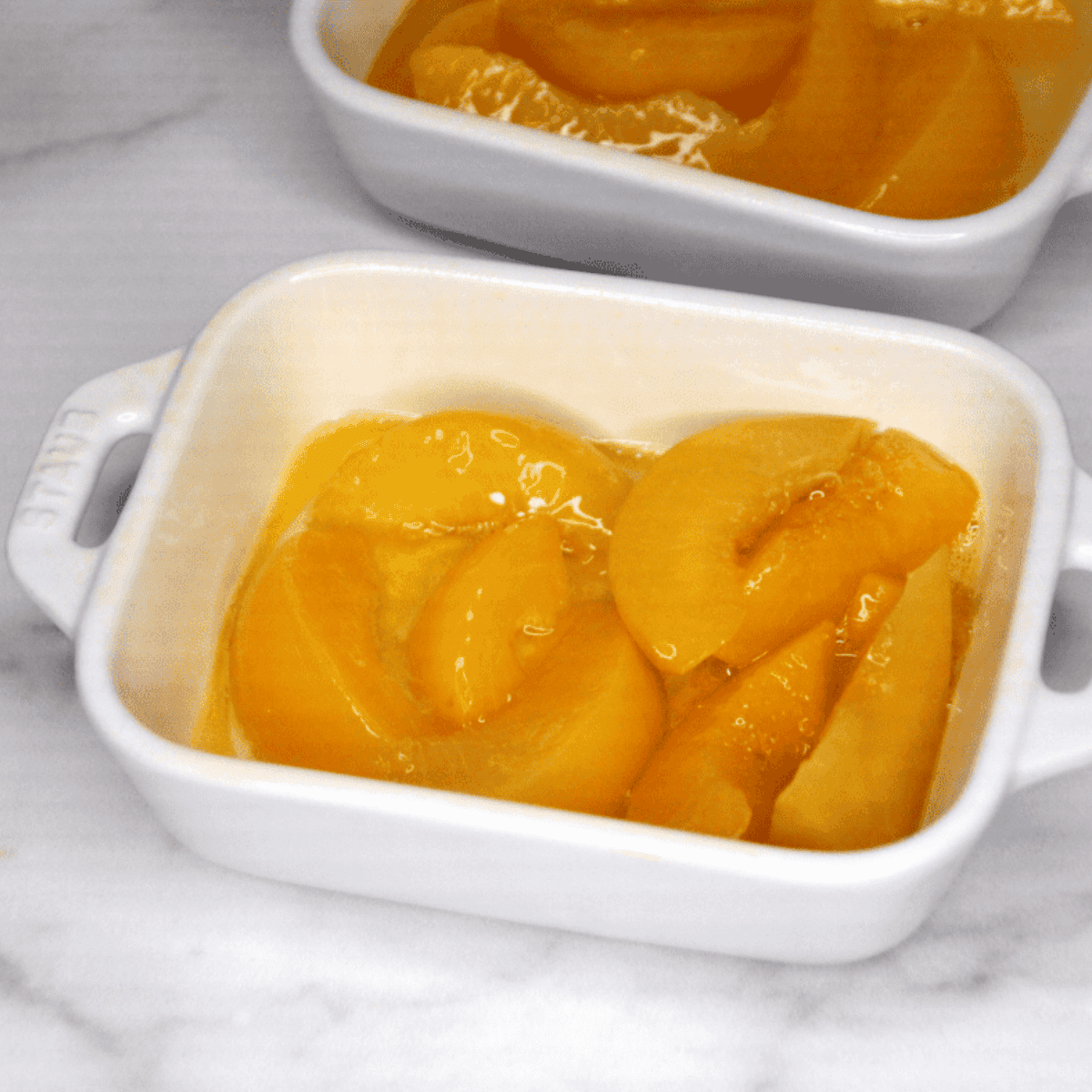 Start by draining the peaches; use paper towels to remove any excess liquid from the peaches.