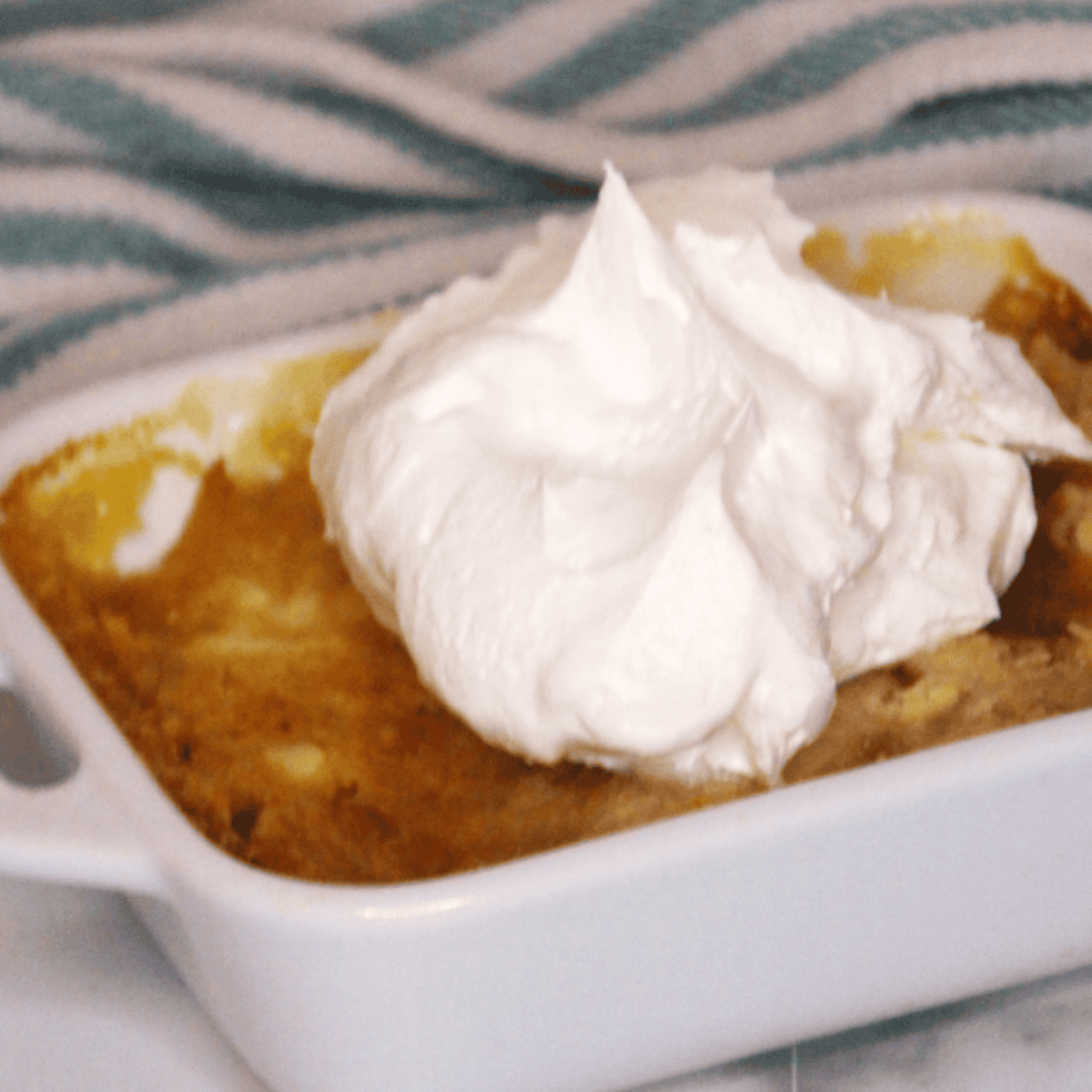 Close-up of golden, crispy Peach Dump Cake with juicy peach filling