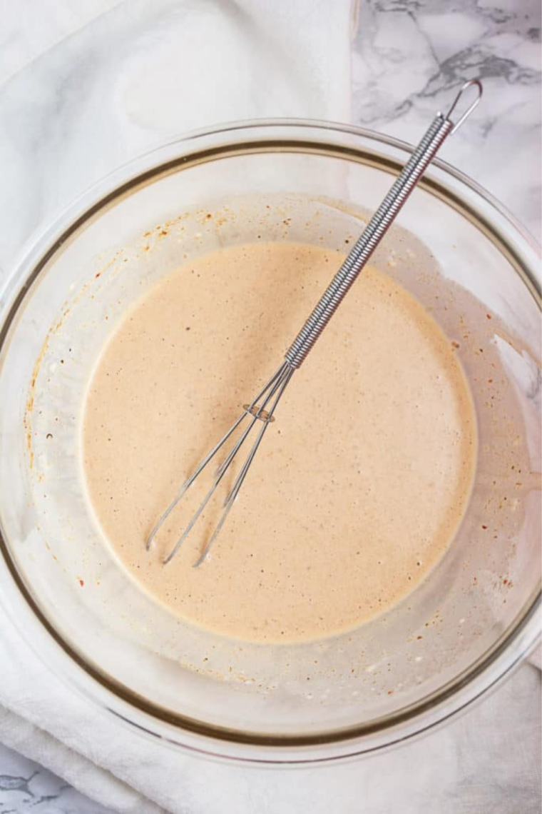 Chipotle lime mayo dressing whisked together in a small bowl.