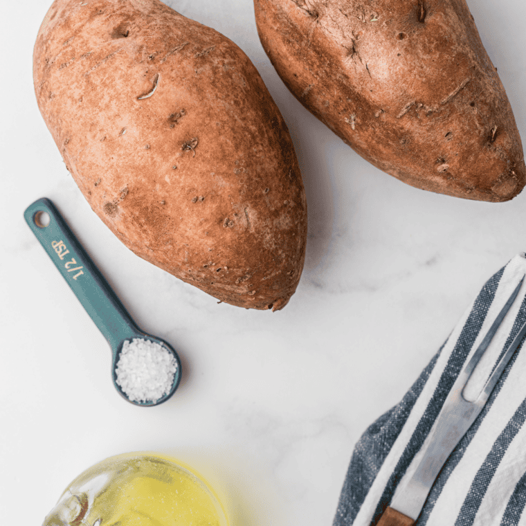 Ingredients for reheating sweet potatoes in an air fryer: cold baked sweet potatoes, olive oil, and salt