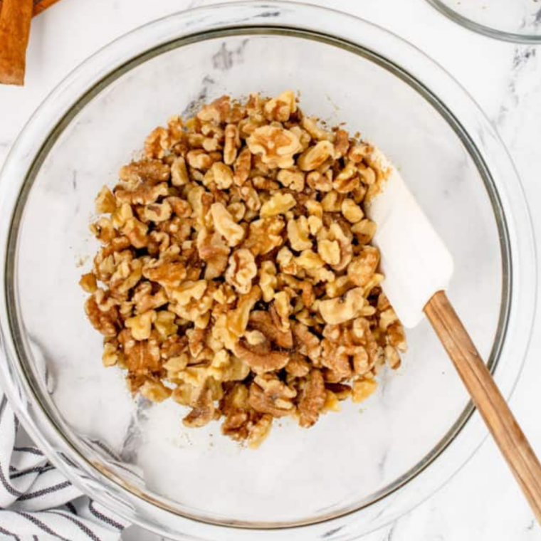 Air fryer basket preheating at 320&deg;F with parchment paper lining, prepared for honey roasted walnuts.