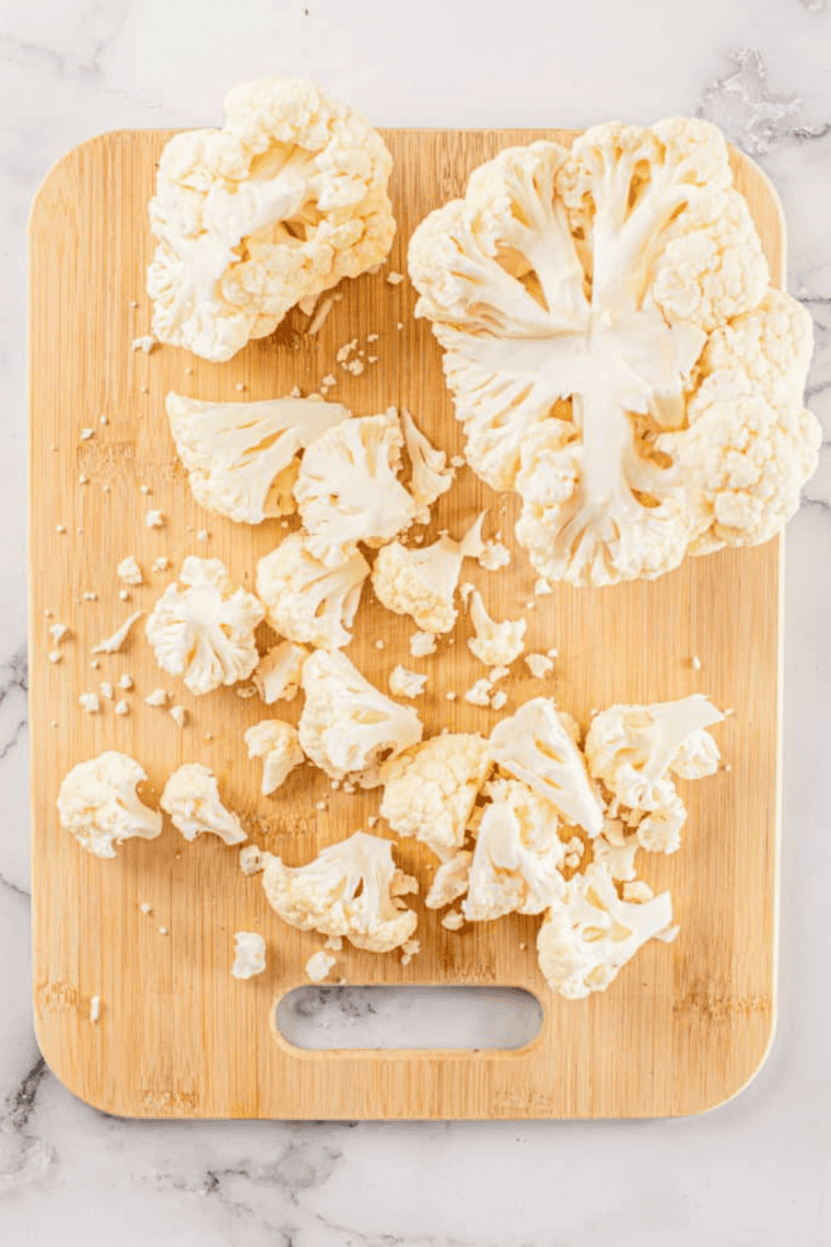 Ingredients needed for Air Fryer Cauliflower With Tomatoes on kitchen table.