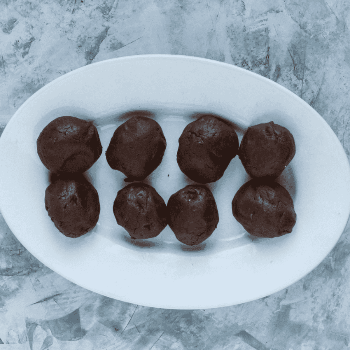 Chocolate shortcake dough divided into eight equal-sized dough balls