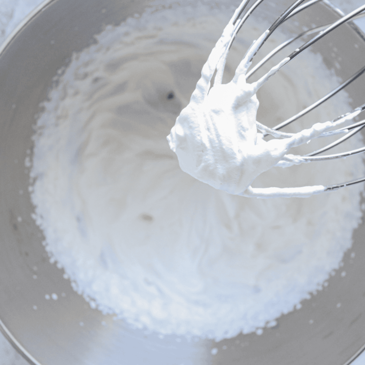 Whipping heavy cream with lemon juice to make homemade whipped cream