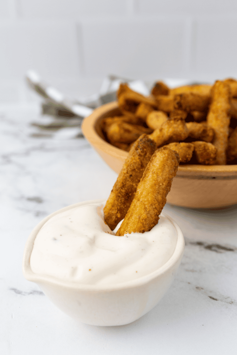 Golden crispy frozen zucchini fries fresh out of the air fryer.