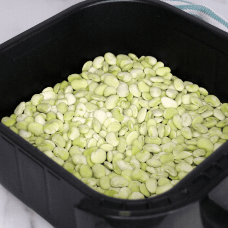 Air fryer preheating to 400 degrees Fahrenheit before cooking frozen lima beans for a crispy texture