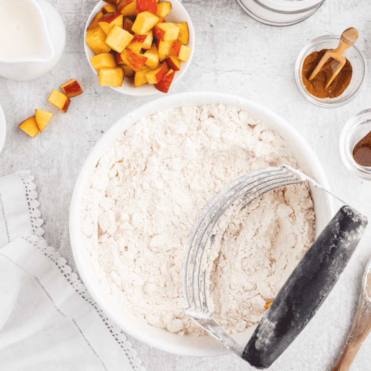 Sifting flour, sugar, baking powder, baking soda, and salt into a medium mixing bowl.
