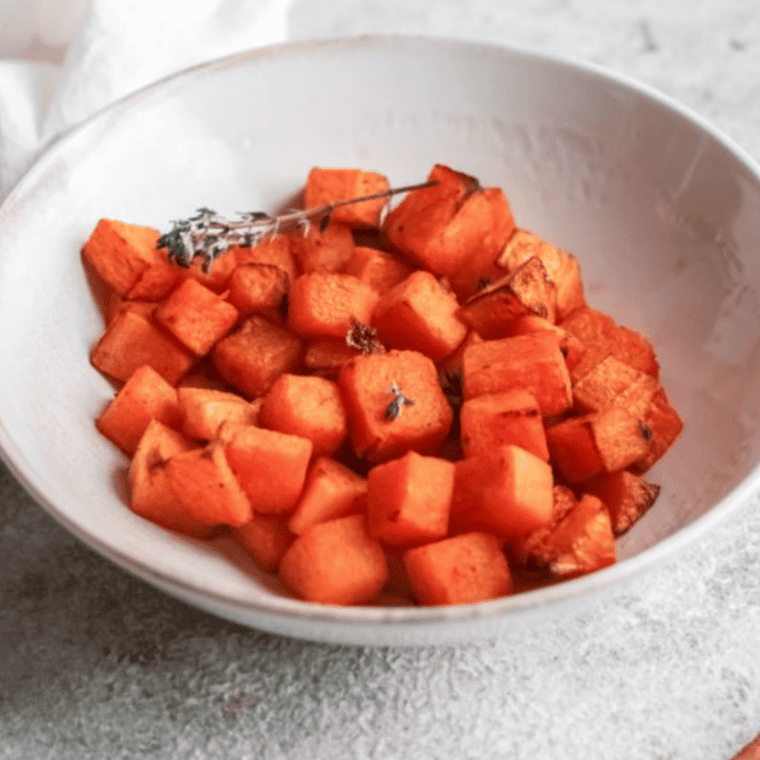 Bowl of Air Fryer Roasted Pumpkin Cubes with caramelized edges and seasonal fall spices