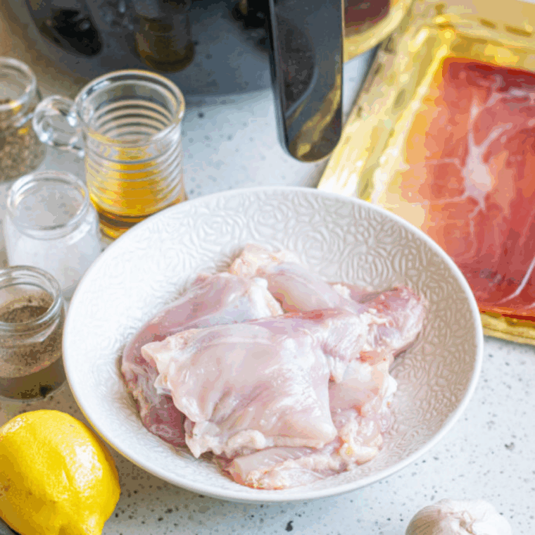 Ingredients needed for Easy Air Fryer Bacon Wrapped Chicken Thighs on kitchen table.