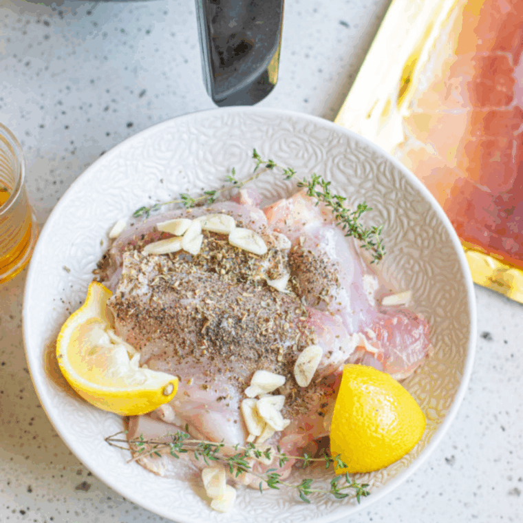 Seasoning boneless chicken thighs with paprika garlic powder onion powder salt and pepper