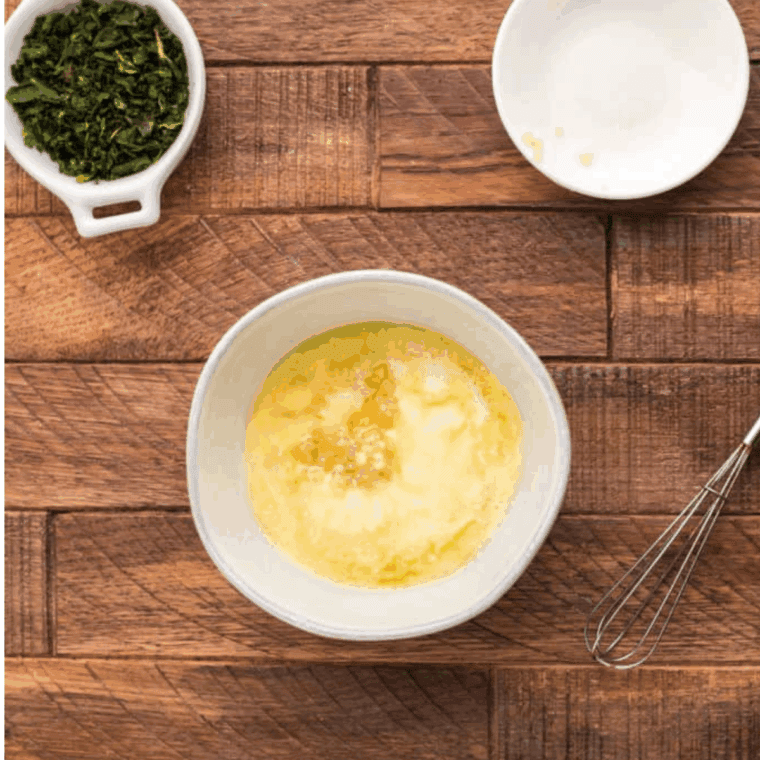 Preheating the air fryer to 390°F while preparing the canned pizza dough on a lightly floured cutting board.