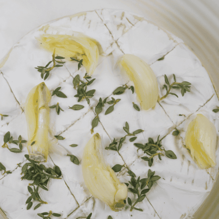 Preheating the air fryer and placing unwrapped Camembert in a small oven-safe dish for baking.