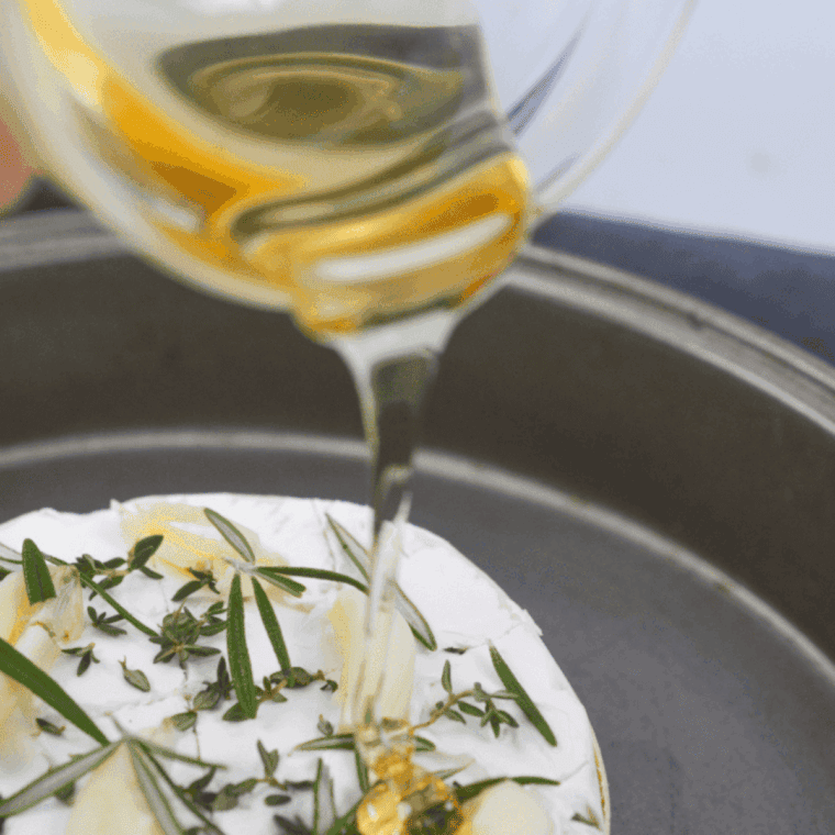Scoring the top of Camembert, drizzling olive oil, and adding fresh herbs before air frying for even melting and extra flavor.