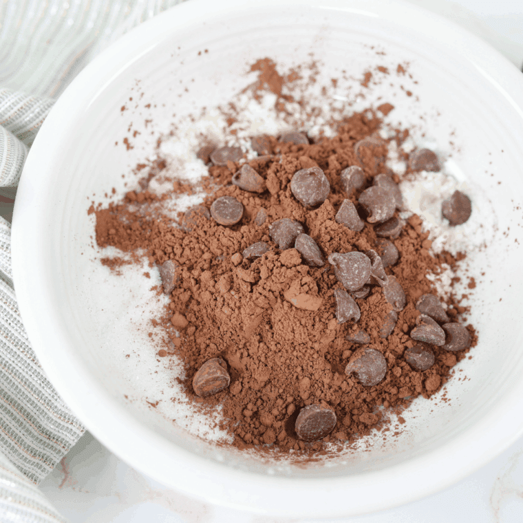 Mixing cream cheese, butter, and sugar in a large bowl until smooth and creamy for bundt pound cake batter.