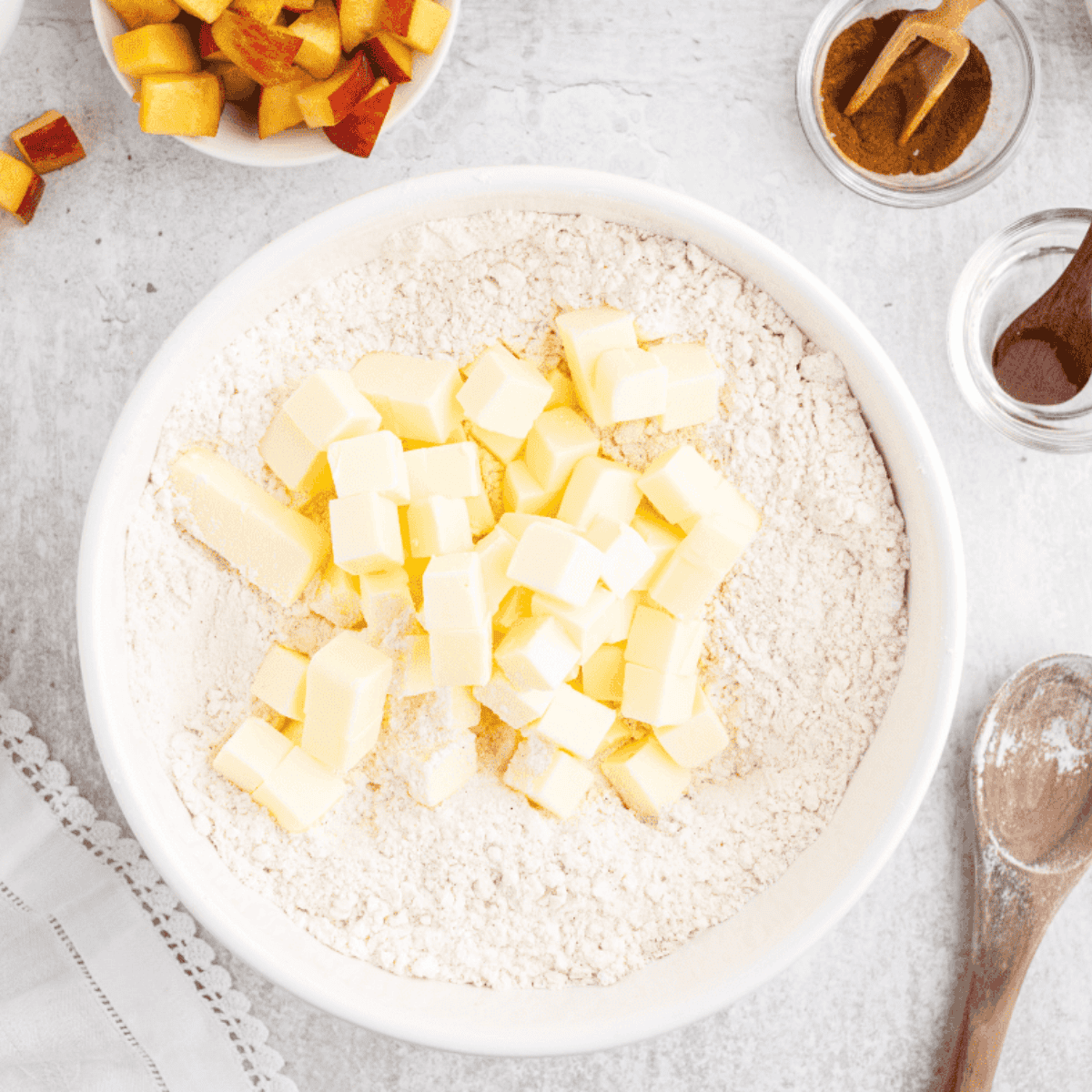 Cutting cold butter into small chunks and blending into dry ingredients until pea-sized.