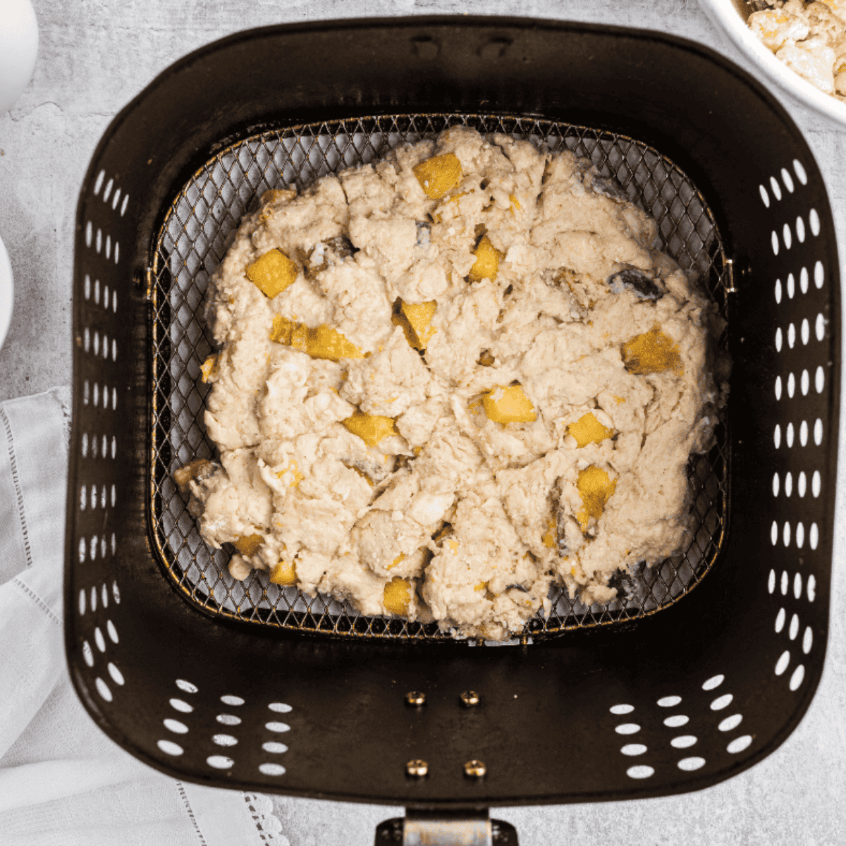 Placing scones in the air fryer and cooking at 350°F for 12–15 minutes until golden brown.