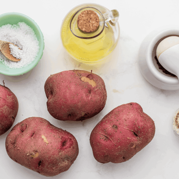 Ingredients needed for Air Fryer Pesto Potatoes on kitchen table.