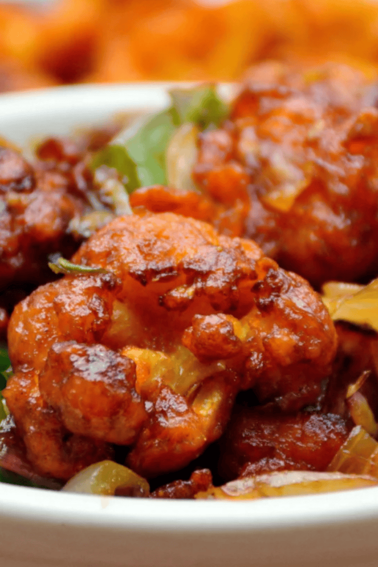Crispy air fryer teriyaki cauliflower served with a small bowl of dipping sauce.