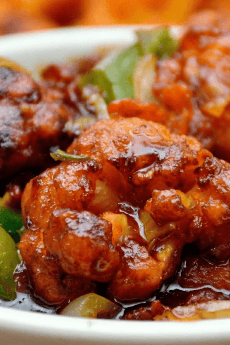 Crispy air fryer cauliflower florets coated in glossy teriyaki sauce, served hot.