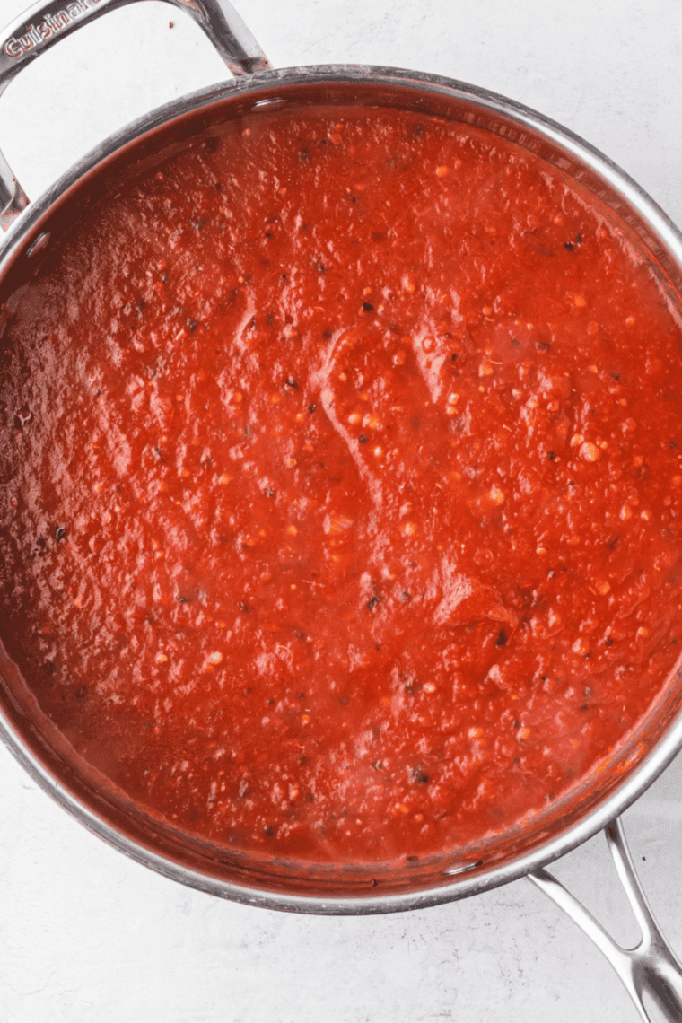 Homemade Little Caesar&rsquo;s style pizza sauce in a bowl, ready to spread on pizza.