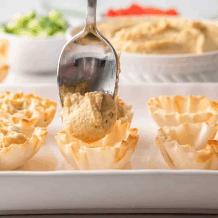 Add hummus to the Phyllo Bites.