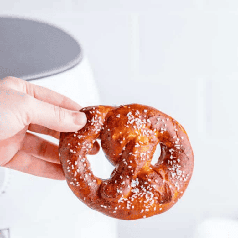 Air fryer copycat Auntie Anne's pretzels brushed with butter and sprinkled with coarse salt