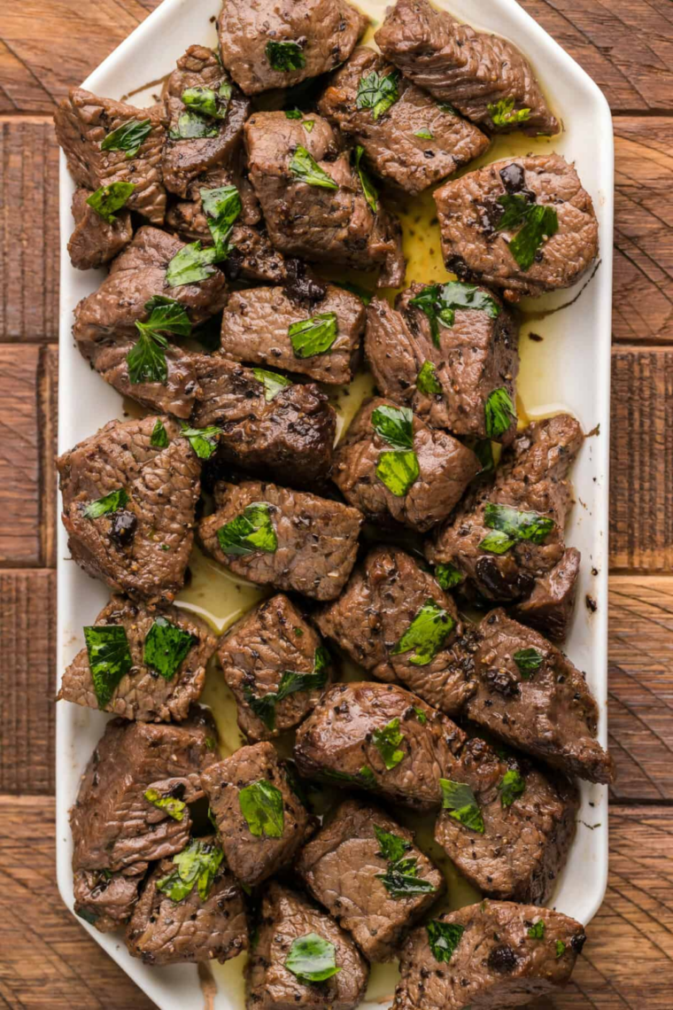 Juicy steak bites seared in an air fryer and tossed in garlic butter sauce, finished with fresh parsley and flaky salt.