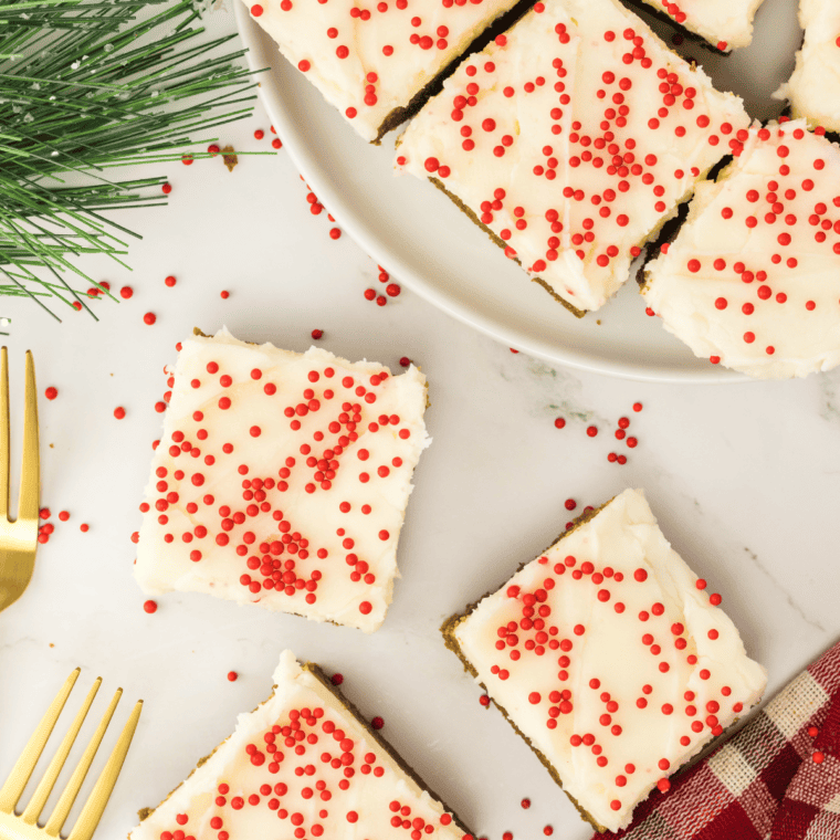Soft, golden-brown Air Fryer Gingerbread Cookie Bars cut into squares on a plate.