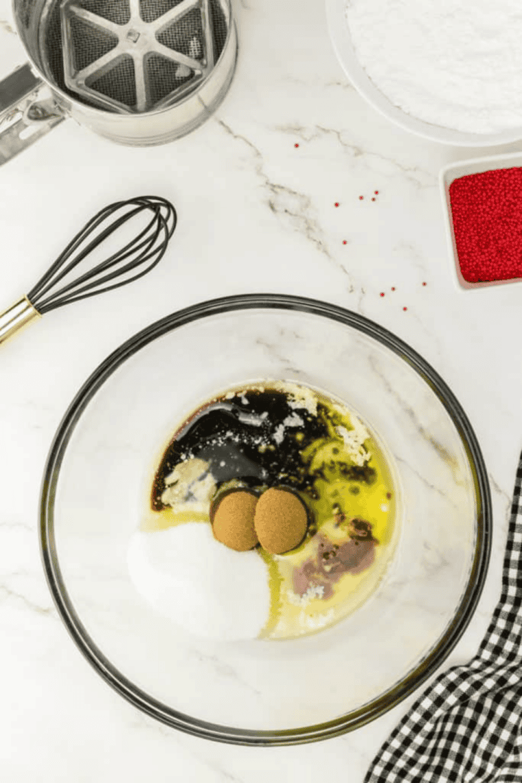 Square baking pan greased with butter and placed inside an air fryer basket with space for airflow.