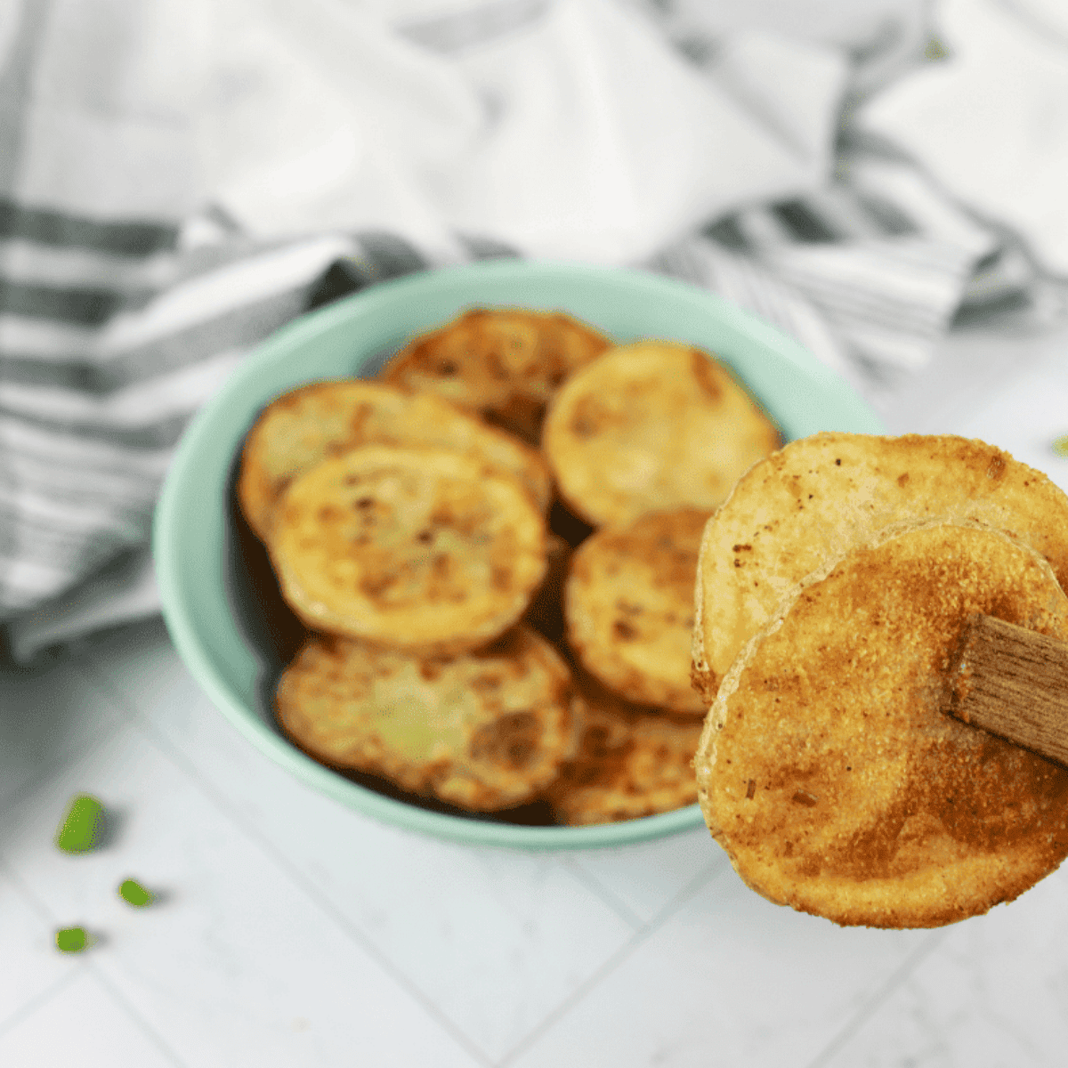 Homemade air fryer sour cream and onion potato chips in a bowl.